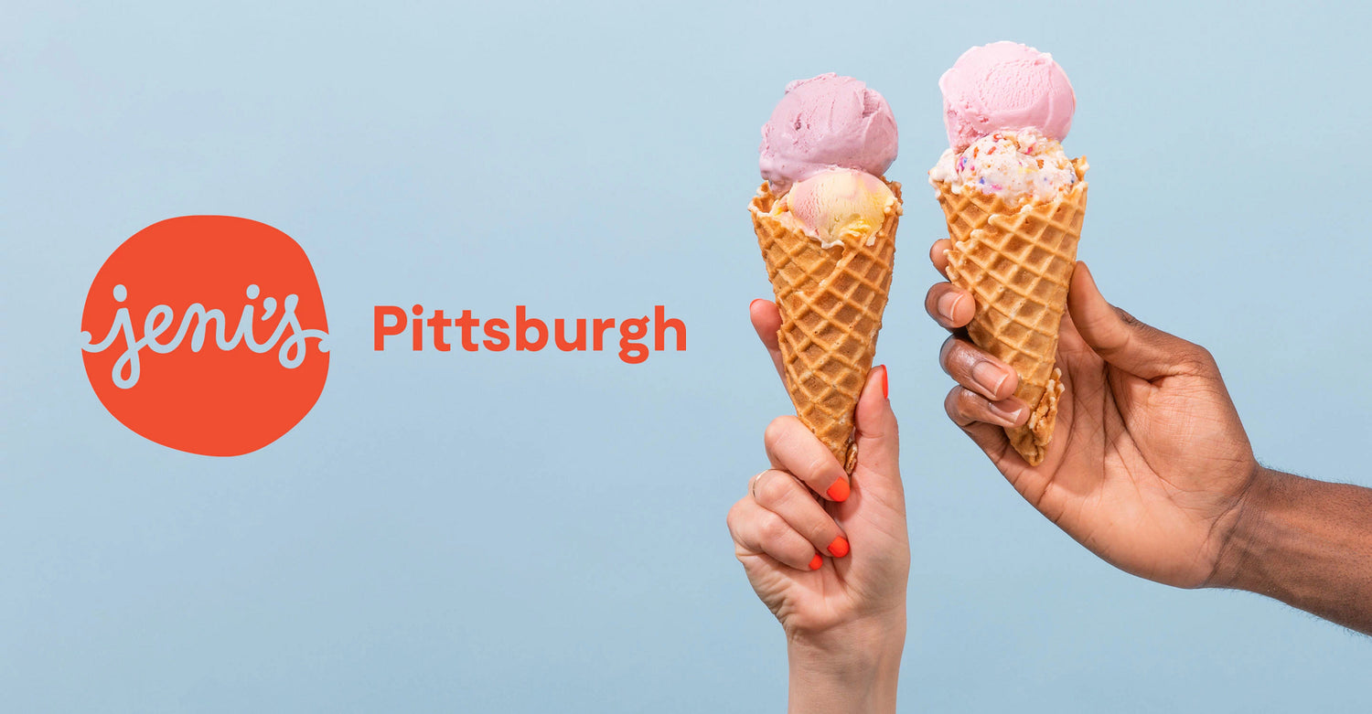 Two hands holding ice cream cones