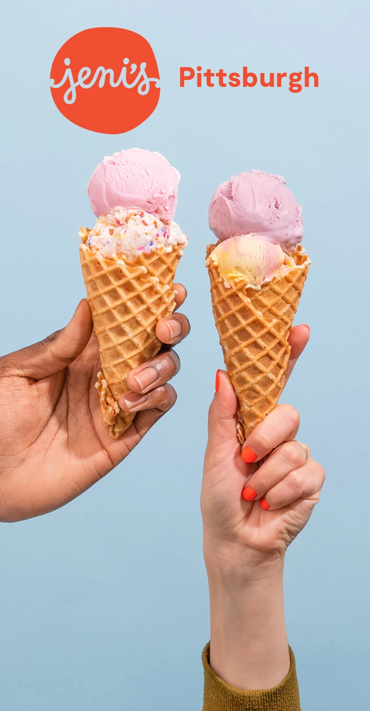 Two hands holding ice cream cones