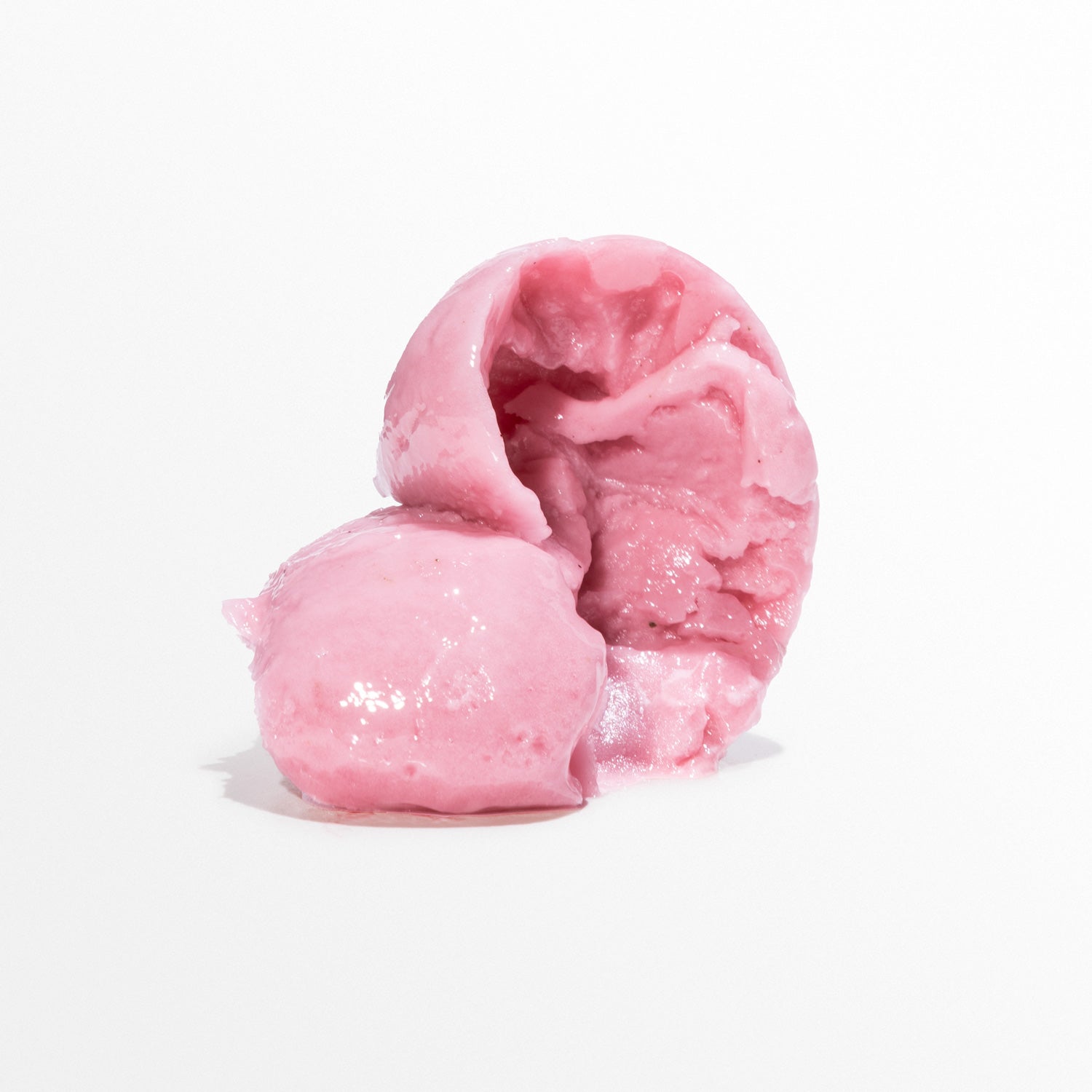 Two scoops of Hibiscus Chili Punch pink sorbet stacked together