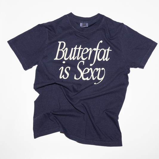Navy blue T-shirt laid flat with white script text reading "Butterfat is Sexy"