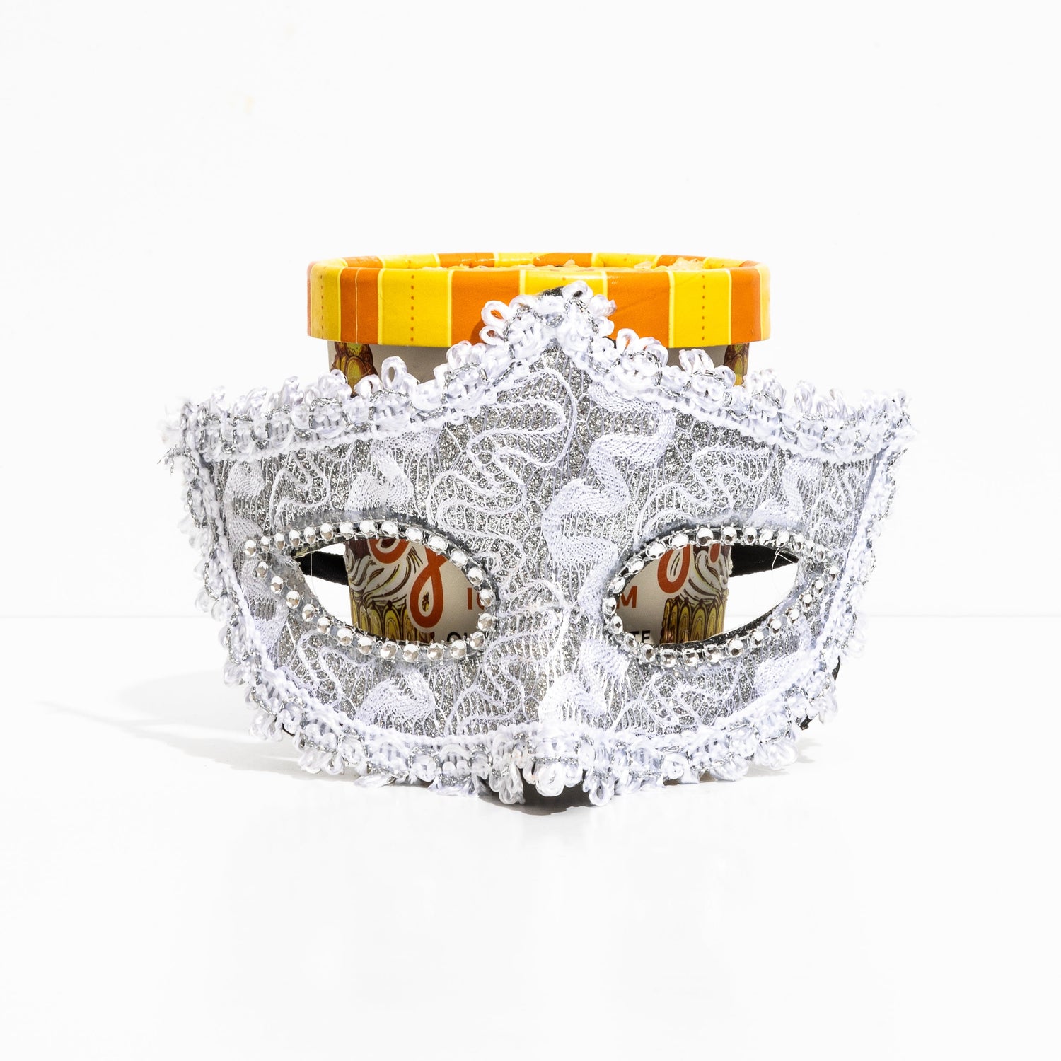Decorative mask with lace details on a white background