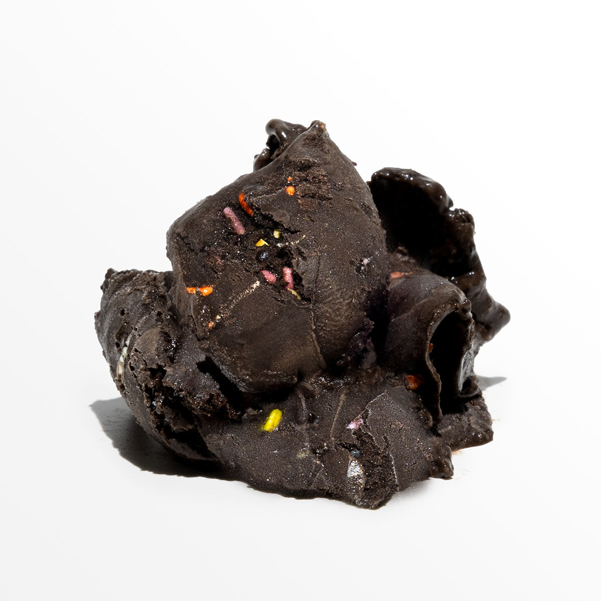 Dark chocolate ice cream with colorful sprinkles on a white background